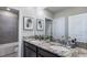 The bathroom has a double vanity with granite countertops and framed mirrors at 4180 Sw 53Rd Lane Rd, Ocala, FL 34474