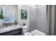 A well-lit bathroom features a granite vanity, tile shower, and decorative accents at 4180 Sw 53Rd Lane Rd, Ocala, FL 34474