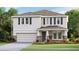 Charming two-story home with stone accents, a covered porch, symmetrical window placement, and well-maintained landscaping at 4180 Sw 53Rd Lane Rd, Ocala, FL 34474