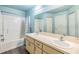 Bathroom with dual sinks, large mirror, tub-shower combo, and neutral colored cabinets at 42 Dogwood Drive Crse, Ocala, FL 34472