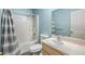 Standard bathroom featuring a shower-tub combo, white toilet and sink, with a large mirror at 42 Dogwood Drive Crse, Ocala, FL 34472