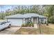 Charming single-story home with a well-maintained lawn, beautiful landscaping, and a gray roof at 42 Dogwood Drive Crse, Ocala, FL 34472