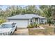 Charming single-story home with a well-maintained lawn, beautiful landscaping, and a gray roof at 42 Dogwood Drive Crse, Ocala, FL 34472
