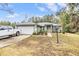 Charming single-story home with a well-maintained lawn, beautiful landscaping, and a gray roof at 42 Dogwood Drive Crse, Ocala, FL 34472