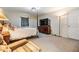 Spacious main bedroom featuring a large bed, TV, dresser, soft carpet, and natural light at 42 Dogwood Drive Crse, Ocala, FL 34472