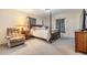 Large main bedroom featuring a four poster bed, sitting area, natural light, and soft carpet at 42 Dogwood Drive Crse, Ocala, FL 34472