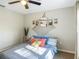 This is a bedroom featuring a bed, decorations on the wall, and a window with curtains at 5092 Sw 197Th Ter, Dunnellon, FL 34431