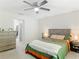 Large bedroom includes en suite bathroom, ceiling fan, and nice dresser at 5092 Sw 197Th Ter, Dunnellon, FL 34431