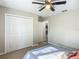 Bright bedroom featuring carpet flooring, ceiling fan and closet with paneled doors at 5092 Sw 197Th Ter, Dunnellon, FL 34431