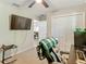 This is a carpeted bedroom with a ceiling fan, a closet, and an office setup with two monitors on a desk at 5092 Sw 197Th Ter, Dunnellon, FL 34431