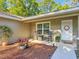 Inviting front porch with rocking chairs and decor, enhanced by fresh landscaping and a welcoming entrance at 5092 Sw 197Th Ter, Dunnellon, FL 34431