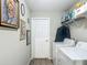 Well-lit laundry area with stacked washer and dryer, plus shelving and artwork at 5092 Sw 197Th Ter, Dunnellon, FL 34431