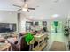 Open concept living room featuring modern furnishings, wood flooring, and seamless access to the kitchen at 5092 Sw 197Th Ter, Dunnellon, FL 34431