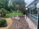 Beautiful backyard with decorative landscaping and access to a screened-in pool area for outdoor enjoyment and relaxation at 6512 Sw 60Th Ct, Ocala, FL 34474