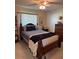 Relaxing bedroom featuring a wood bed frame, soft lighting, and a serene, inviting atmosphere at 6512 Sw 60Th Ct, Ocala, FL 34474