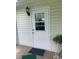 The well-lit white door has a window and modern black sconce near an exterior home entrance at 6512 Sw 60Th Ct, Ocala, FL 34474
