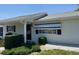 Well-maintained home exterior with roll-down shades, neat landscaping, and inviting curb appeal at 6512 Sw 60Th Ct, Ocala, FL 34474