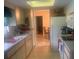 Functional kitchen featuring light cabinets, laminate countertops, and natural light streaming through a skylight at 6512 Sw 60Th Ct, Ocala, FL 34474