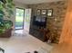 Inviting living room featuring a stone accent wall and a fireplace, creating a warm atmosphere at 6512 Sw 60Th Ct, Ocala, FL 34474