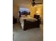 Comfortable main bedroom with a wooden bed frame, carpet flooring, and soft, natural light at 6512 Sw 60Th Ct, Ocala, FL 34474