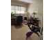 Bright home office space featuring a desk, large window, and exercise equipment at 6512 Sw 60Th Ct, Ocala, FL 34474