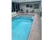 Inviting screened-in pool area with sparkling blue water and ample space for relaxation and outdoor enjoyment at 6512 Sw 60Th Ct, Ocala, FL 34474