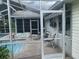 Enclosed patio with a pool, comfortable seating, and views of the outdoor space at 6512 Sw 60Th Ct, Ocala, FL 34474