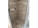 Tiled corner shower showcasing natural stone floors and a modern design for a spa-like experience at 6512 Sw 60Th Ct, Ocala, FL 34474