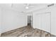 Bedroom features hard wood floors, ceiling fan and closet with full length doors at 6776 Sw 151St Loop, Ocala, FL 34473