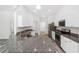 Modern kitchen features granite countertops, stainless steel appliances, and ample white cabinetry at 6776 Sw 151St Loop, Ocala, FL 34473