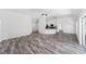 Open concept living area features luxury vinyl flooring, modern ceiling fan and an adjacent kitchen at 6776 Sw 151St Loop, Ocala, FL 34473
