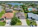 Aerial shot of a lakeside home featuring a well-manicured lawn and mature trees at 779 Oldsmar Ter, The Villages, FL 32163