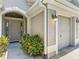 Close-up of the front door with decorative glass panels, next to the garage at 779 Oldsmar Ter, The Villages, FL 32163