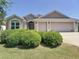 Charming single-story home with a well-manicured lawn and a three-car garage at 779 Oldsmar Ter, The Villages, FL 32163