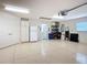 Organized garage with epoxy floors, ample storage, and room for multiple vehicles at 779 Oldsmar Ter, The Villages, FL 32163
