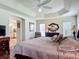 Spacious main bedroom with tray ceiling, wood floors, and ensuite bath access at 779 Oldsmar Ter, The Villages, FL 32163