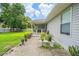 Charming home featuring a covered porch, well-manicured lawn, and delightful landscaping at 9 Fir Trail Pass, Ocala, FL 34472