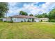 Charming home exterior with a well-manicured lawn, providing a welcoming curb appeal at 9 Fir Trail Pass, Ocala, FL 34472