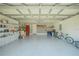 Spacious garage offering ample storage space and room for parking, complete with shelving and a well-lit interior at 9 Fir Trail Pass, Ocala, FL 34472