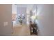 Neutral hallway leading to the main living area, featuring decorative art, light fixtures, and carpet at 9 Fir Trail Pass, Ocala, FL 34472