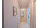 Hallway with white doors, tile flooring and view to a bedroom at 9 Fir Trail Pass, Ocala, FL 34472