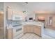 Kitchen featuring white appliances, neutral countertops, and open view to dining area at 9 Fir Trail Pass, Ocala, FL 34472