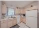 Bright kitchen features white appliances, neutral countertops, and ample cabinet space at 9 Fir Trail Pass, Ocala, FL 34472