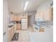 Bright kitchen with white appliances, neutral countertops, and plenty of cabinet space at 9 Fir Trail Pass, Ocala, FL 34472