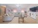 Bright and airy living room with plush seating, neutral paint, and modern TV at 9 Fir Trail Pass, Ocala, FL 34472