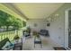 Inviting covered porch with neutral tile, comfortable seating, and decorative accents at 9 Fir Trail Pass, Ocala, FL 34472