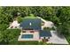 Aerial view of the property showcasing the pool, garage and circular driveway, all surrounded by lush trees at 950 Sw 43Rd Pl, Ocala, FL 34471