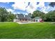 Expansive backyard featuring a refreshing pool and ample green space, perfect for outdoor relaxation and entertainment at 950 Sw 43Rd Pl, Ocala, FL 34471