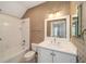 Nicely decorated bathroom with vanity, mirror, shower and tub combo, and patterned wallpaper at 950 Sw 43Rd Pl, Ocala, FL 34471