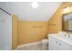 Small bathroom with yellow wallpaper, vanity, mirror, shower and tub combo, and tile flooring at 950 Sw 43Rd Pl, Ocala, FL 34471